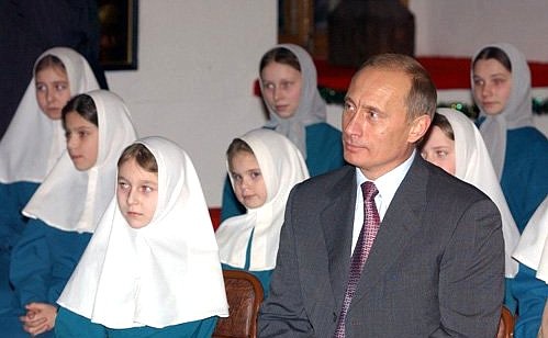 President Putin at a holiday concert in the Bishop\'s Chambers with girls from the Nadezhda Boarding School at the Svyato-Troitsky Monastery.