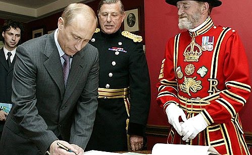 Vladimir Putin making an entry in the honoured guests book during a visit to the Tower of London.