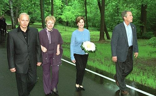 President Vladimir Putin and his wife, Lyudmila, during a walk with US President George Bush and his wife, Laura.