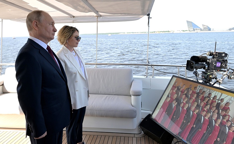 Vladimir Putin took part in a ceremony of raising the flags of the Russian Federation, the USSR and the Russian Empire on the coast of the Gulf of Finland. With Yelena Ilyukhina, Deputy General Director of Gazprom Neft and General Director of Gazprom Lakhta.