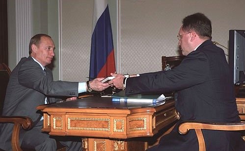 Mikhail Vanin, Chairman of the State Customs Committee, presenting President Putin with the first copy of the Customs Code, which comes into force as of January 1, 2004.