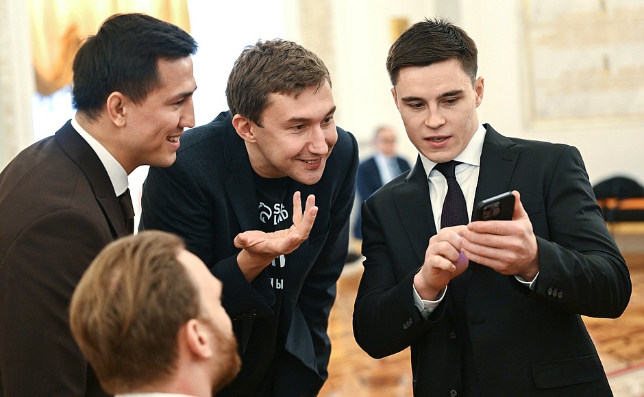 Chess player, Grandmaster Sergei Karyakin, center, and Olympic champion on rhythmic gymnastics Nikita Nagorny, right, before a meeting with trusted representatives.