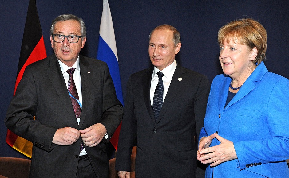 With Federal Chancellor of Germany Angela Merkel and President of the European Commission Jean-Claude Juncker.