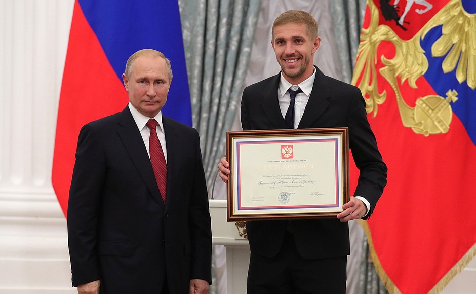 A letter of recognition for contribution to the development of Russia football and high athletic achievement is presented to Russia national football team player Yury Gazinsky.