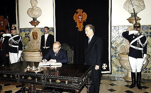 Vladimir Putin signing the guest book.