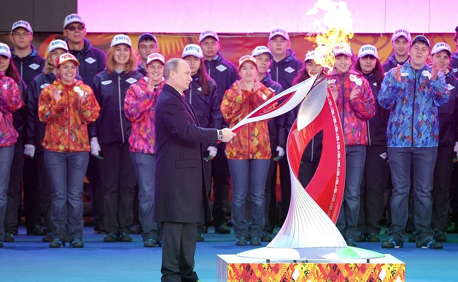 Vladimir Putin lights the Olympic flame.