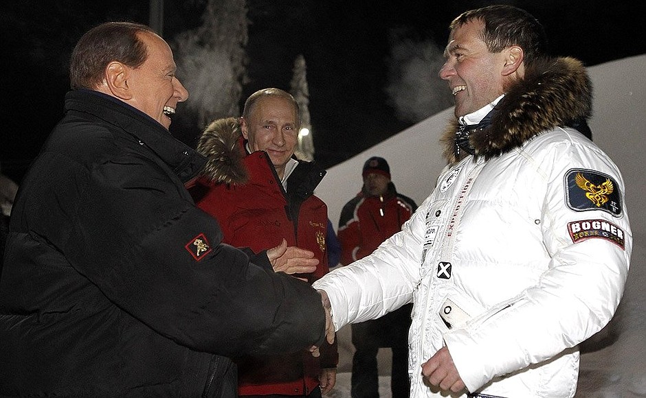 With Vladimir Putin and Silvio Berlusconi.
