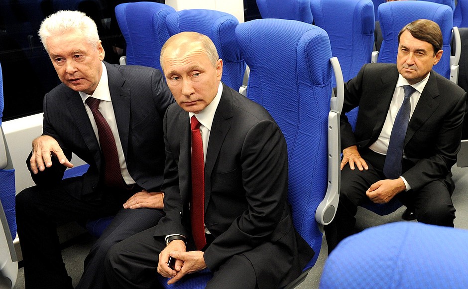 With Moscow Mayor Sergei Sobyanin (left) and Presidential Aide Igor Levitin aboard the Lastochka electric train on the Moscow Central Ring railway.