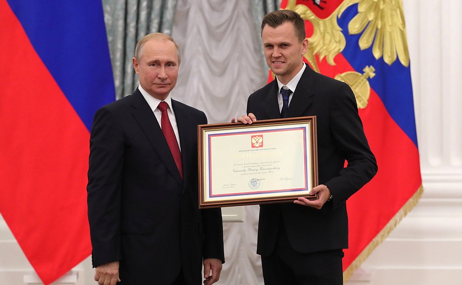 A letter of recognition for contribution to the development of Russia football and high athletic achievement is presented to Russia national football team player Denis Cheryshev.