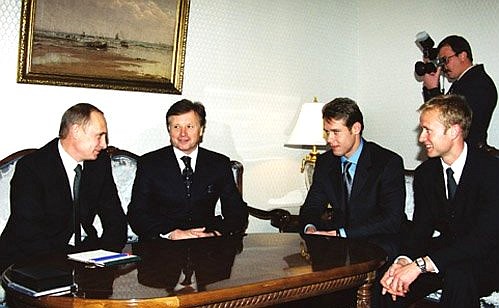 President Vladimir Putin meeting with leading Russian ice hockey players. From left to right with the President, National Olympic Committee President Leonid Tyagachev, and Pavel and Valery Bure.