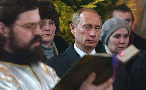 President Putin attending a service at the Church of the Sign of the Holy Mother of God.
