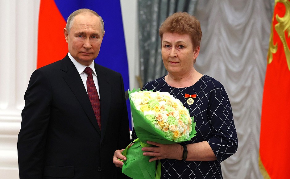Ceremony for presenting state decorations. The Merit Badge For Mentorship is awarded to Nina Okulova, teacher and mentor of Hero of the Russian Federation Sergei Polushin.