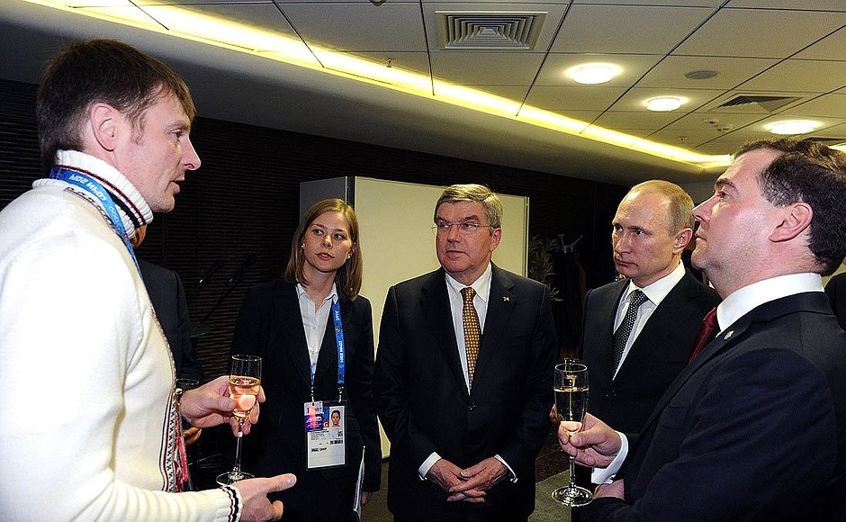 Before the closing ceremony of the XXII 2014 Winter Olympics. With two-time Olympic champion in bobsleigh at the Sochi Games Alexander Zubkov (far left), President of the International Olympic Committee Thomas Bach and Prime Minister Dmitry Medvedev.