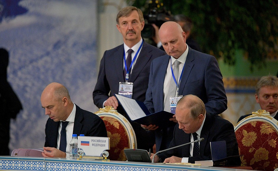 Signing documents following the CIS Heads of State Council meeting.