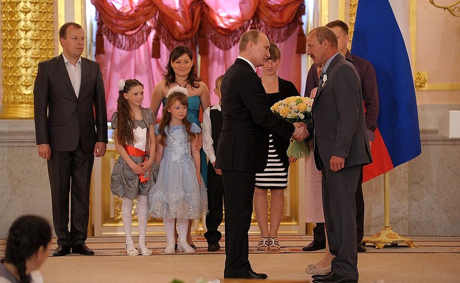 Presenting the Order of Parental Glory to Tatyana and Gennady Morokov, who are raising 12 children.