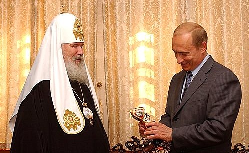 Patriarch of Moscow and All Russia Alexii II presenting an Easter egg to President Putin.