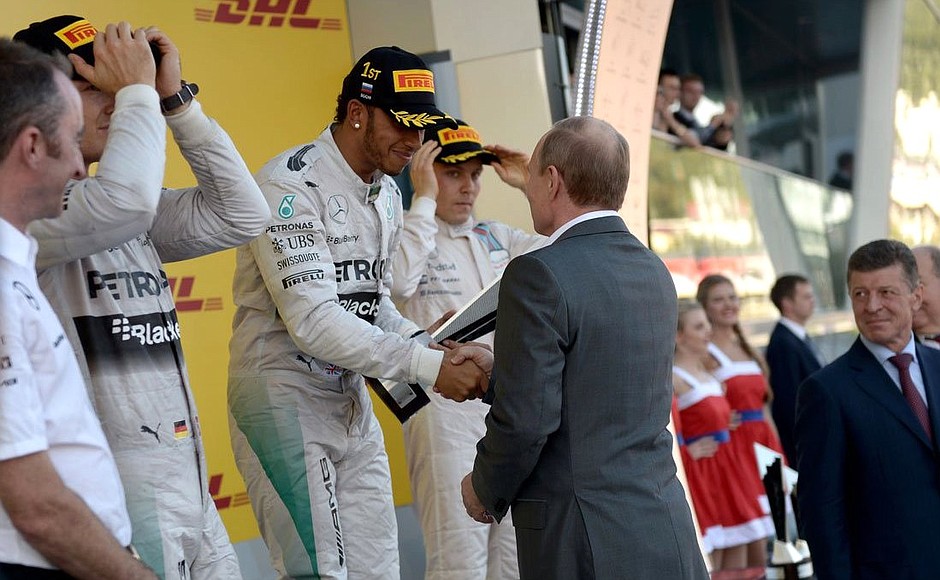 Vladimir Putin presented the cup to Lewis Hamilton, winner of the Russian stage of the Formula One World Championship.