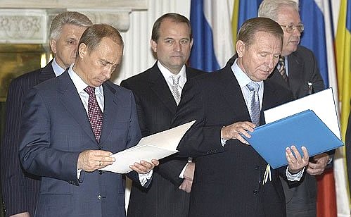 President Putin exchanging documents for ratification with Ukrainian President Leonid Kuchma.