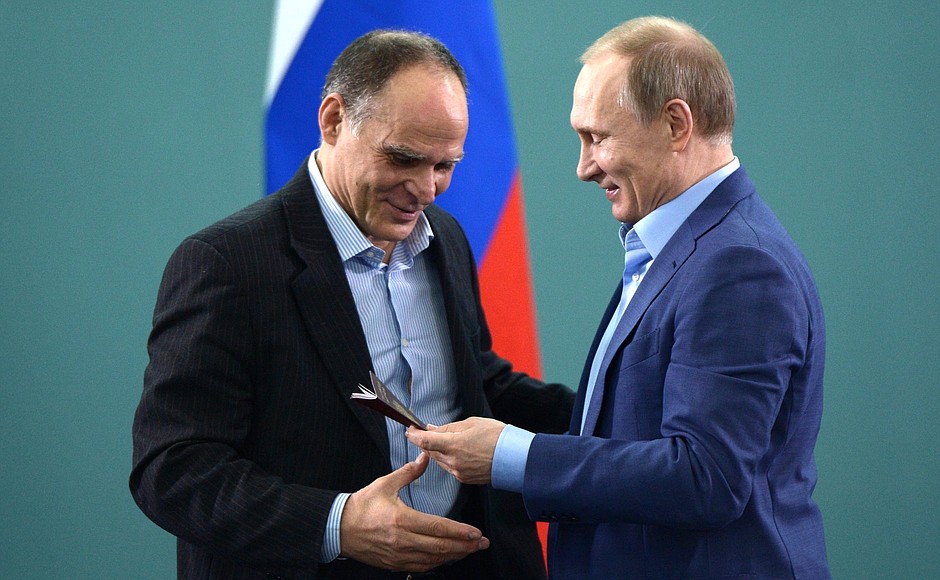 Vladimir Putin presented the Russian passport to national judo team head coach Ezio Gamba.