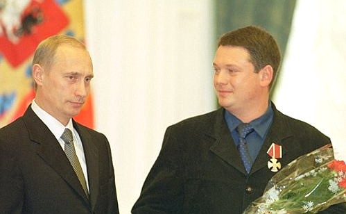 President Vladimir Putin conferring state awards on a group of Russian journalists. Oleg Groznetsky, Baltic office head of the ORT national television, receives the Order of Valour.