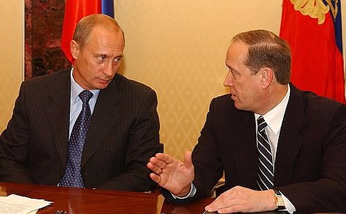 President Putin at a meeting with members of the Central Election Commission. Right: chairman of the Central Election Commission Alexander Veshnyakov.