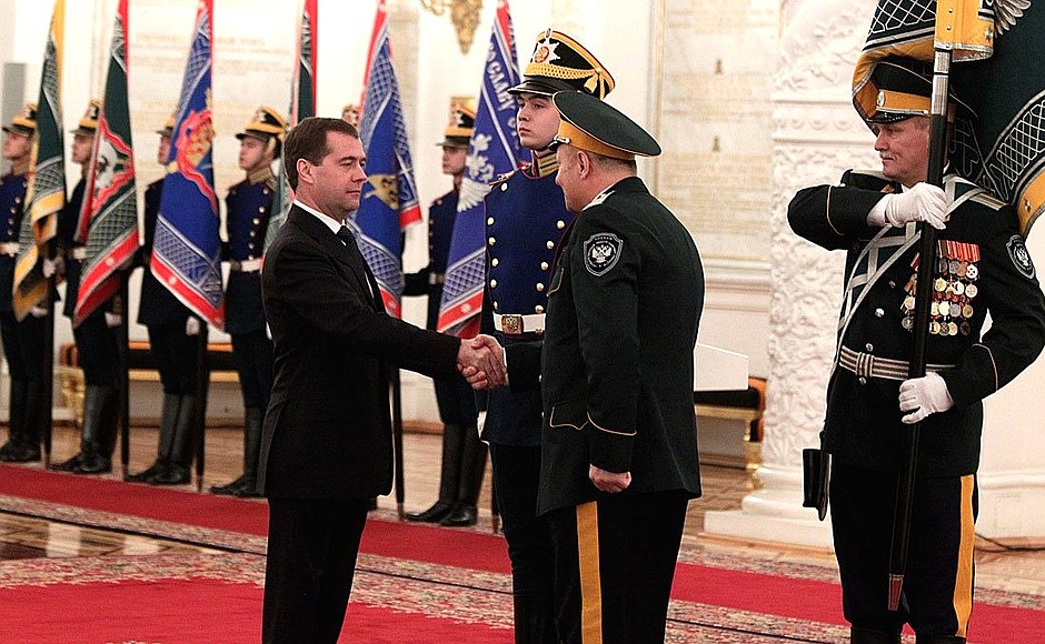 Presenting banners to Cossack military societies. Dmitry Medvedev presents the banner of Ussuriysk Cossack military society to ataman Oleg Melnikov.