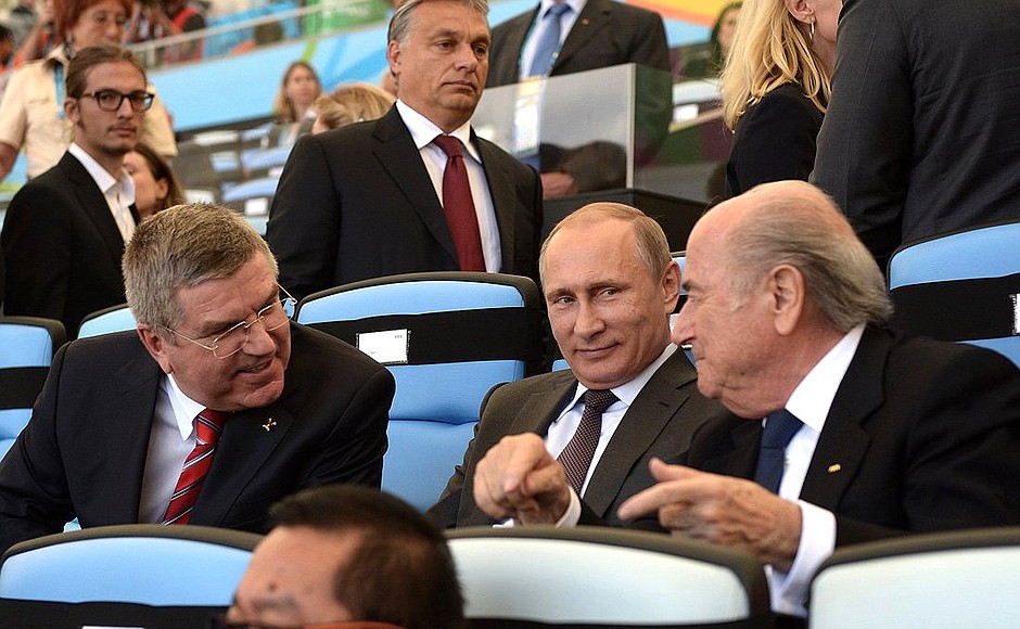 During the 2014 FIFA World Cup’s closing ceremony at the Maracana Stadium. With President of the International Olympic Committee Thomas Bach (left) and FIFA President Joseph Blatter.