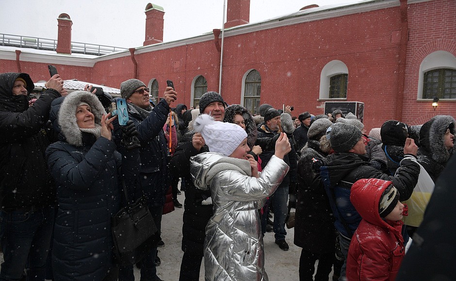 At Peter and Paul Fortress public festivities. Vladimir Putin is photographed with city residents and tourists.