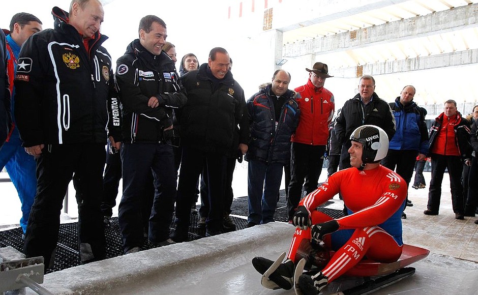 With Prime Minister Vladimir Putin and Silvio Berlusconi during test runs on the sledding and bobsleigh track.