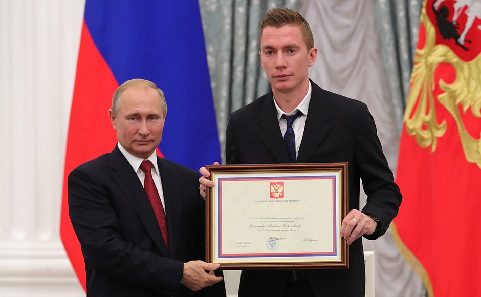 A letter of recognition for contribution to the development of Russia football and high athletic achievement is presented to Russia national football team player Andrei Semyonov.