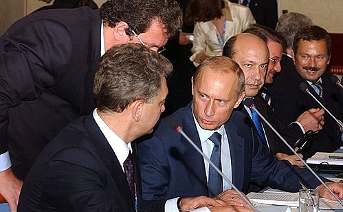 President Putin during the plenary meeting of the Russia-European Union summit with his aide Sergei Prikhodko and Russian Deputy Prime Minister Viktor Khristenko.