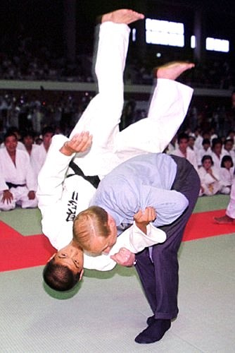 President Putin meeting with young athletes at the Gushikawa sports centre and performing judo exercises.