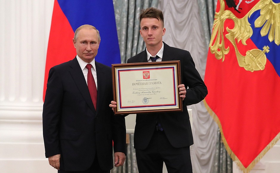 A letter of recognition for contribution to the development of Russia football and high athletic achievement is presented to Russia national football team player Alexander Golovin.