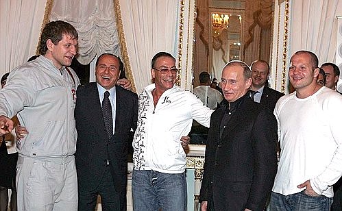 From left to right: with participant in the mixed martial arts tournament Alexander Yemelyanenko, former Italian Prime Minister Silvio Berlusconi, actor Jean-Claude Van Damme, and absolute mixed-style world champion Fyodor Yemelyanenko.