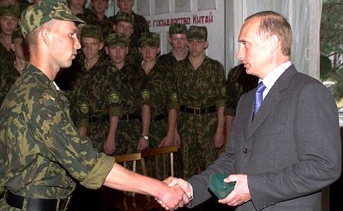 President Putin presenting an engraved watch to Senior Corporal Viktor Zarochentsev during a visit to an outpost of the Blagoveshchensk border unit.