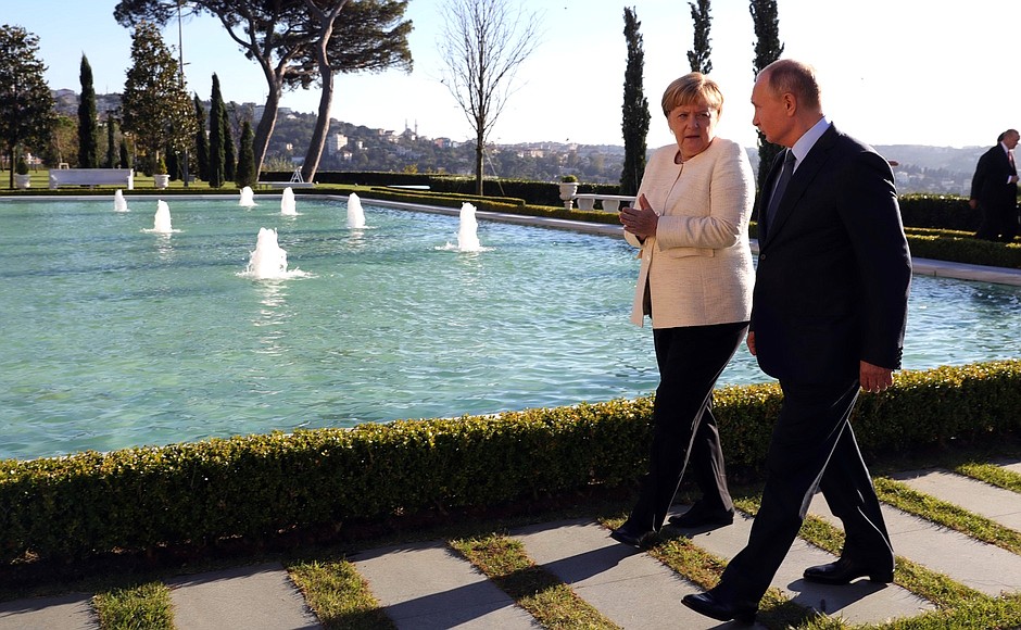 With Federal Chancellor of Germany Angela Merkel before the meeting of the leaders of Russia, Turkey, Germany and France.