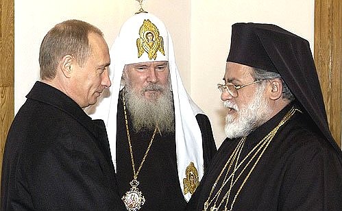 President Vladimir Putin meeting with Alexii II, the Patriarch of Moscow and All Russia and Petros VII, the Pope and Patriarch of Alexandria and all Africa (right).