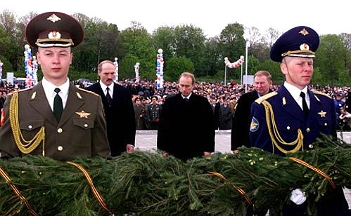 Laying flowers at the foot of the belfry Victory Monument in Prokhorovka Field with presidents Leonid Kuchma of Ukraine and Alexander Lukashenko of Belarus.