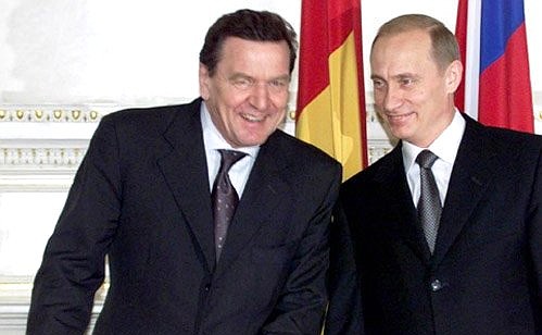 PETERSBURG. President Vladimir Putin and Chancellor Gerhard Schroeder preparing to sign agreements negotiated during Russian-German intergovernmental consultations.