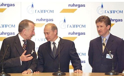 Joint stand of Germany\'s leading natural gas distributor Ruhrgas AG and Russian Gazprom: President Vladimir Putin, Ruhrgas AG board chairman Burkhard Bergman (left) and Gazprom board chairman Alexei Miller, Messe Dusseldorf exhibition complex.