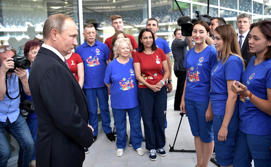 Vladimir Putin talks with 2018 FIFA World Cup Russia volunteers during his visit to Kaliningrad Stadium.