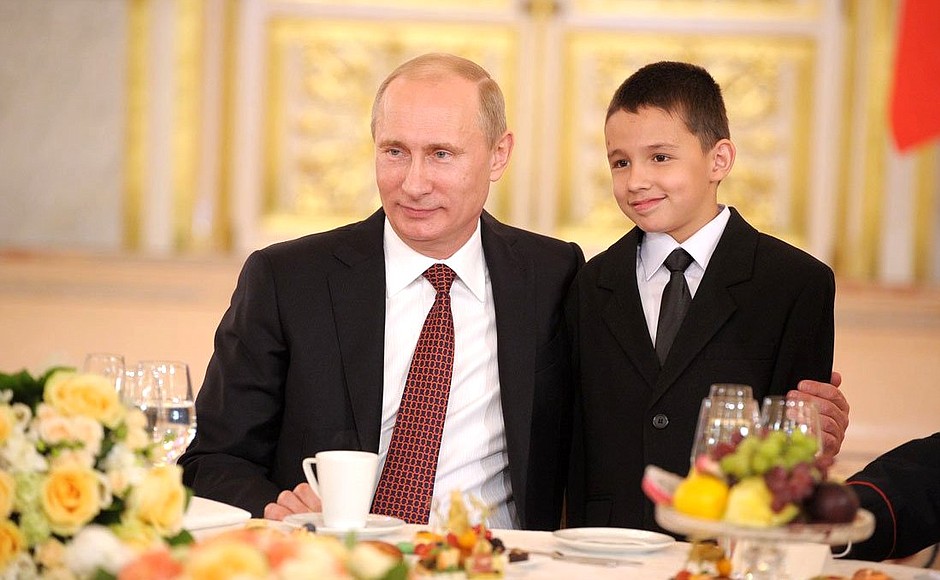 Vladimir Putin and the son of Gulnara and Anatoly Bely, who are raising 8 children.