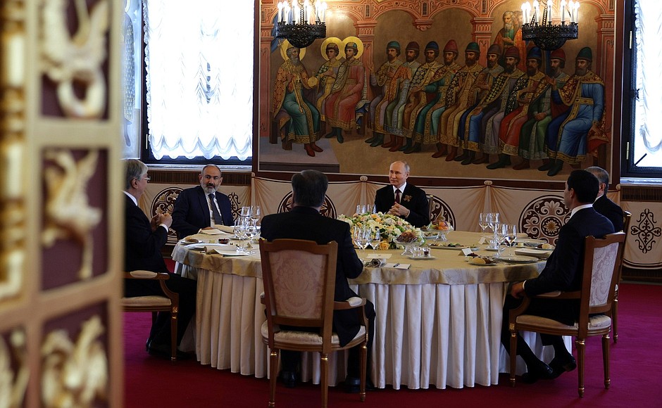 Before a working dinner with heads of foreign states who had arrived in Moscow for the celebration.