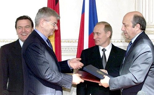 President Vladimir Putin and Chancellor Gerhard Schroeder watching Foreign Ministers Igor Ivanov, right, and Joschka Fischer sign agreements negotiated during Russian-German inter-governmental consultations.
