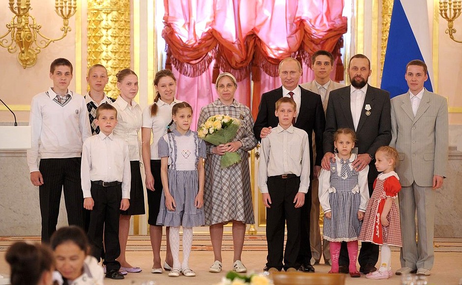 Presenting the Order of Parental Glory to Marina and Sergei Khodyrev, who are raising 12 children.