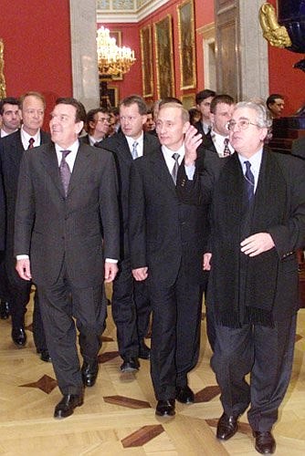 President Vladimir Putin and German Chancellor Gerhard Schroeder touring the State Hermitage Museum together with its head, Mikhail Piotrovsky, right.