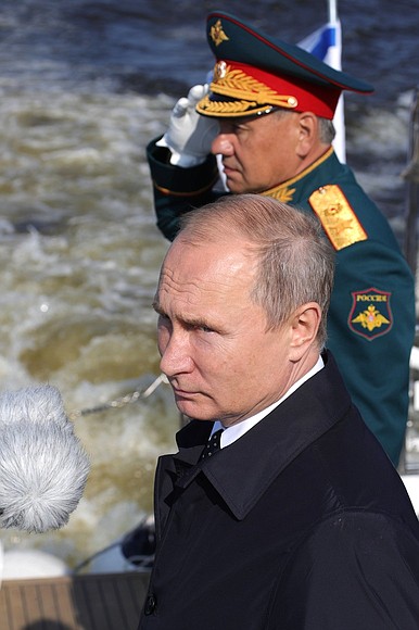 Before the main part of the Main Naval Parade, Vladimir Putin sailed round the combat ships lined up for the parade in the inner harbour of Kronstadt, and welcomed their crews. With Defence Minister Sergei Shoigu.