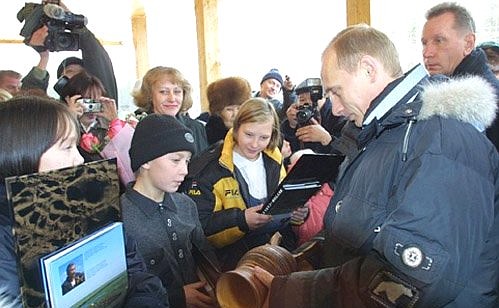 President Putin visiting a school in the village of Novaya Murya, where pupils gave him a choron wooden cup, a symbol of Yakutia.