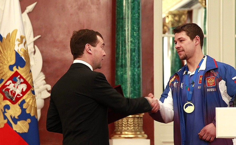 At a meeting with the winners and runners-up of the XXV World Winter Universiade. Captain of the Russian ice hockey team Sergei Salnikov presented to Dmitry Medvedev a commemorative token of the Universiade.
