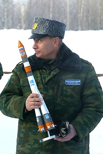 Space centre personnel presenting President Putin with a model of the Molniya rocket in commemoration of the launch.